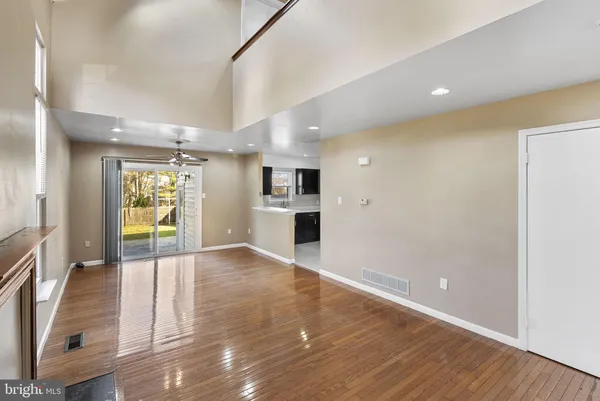 a view of empty room with wooden floor and fireplace