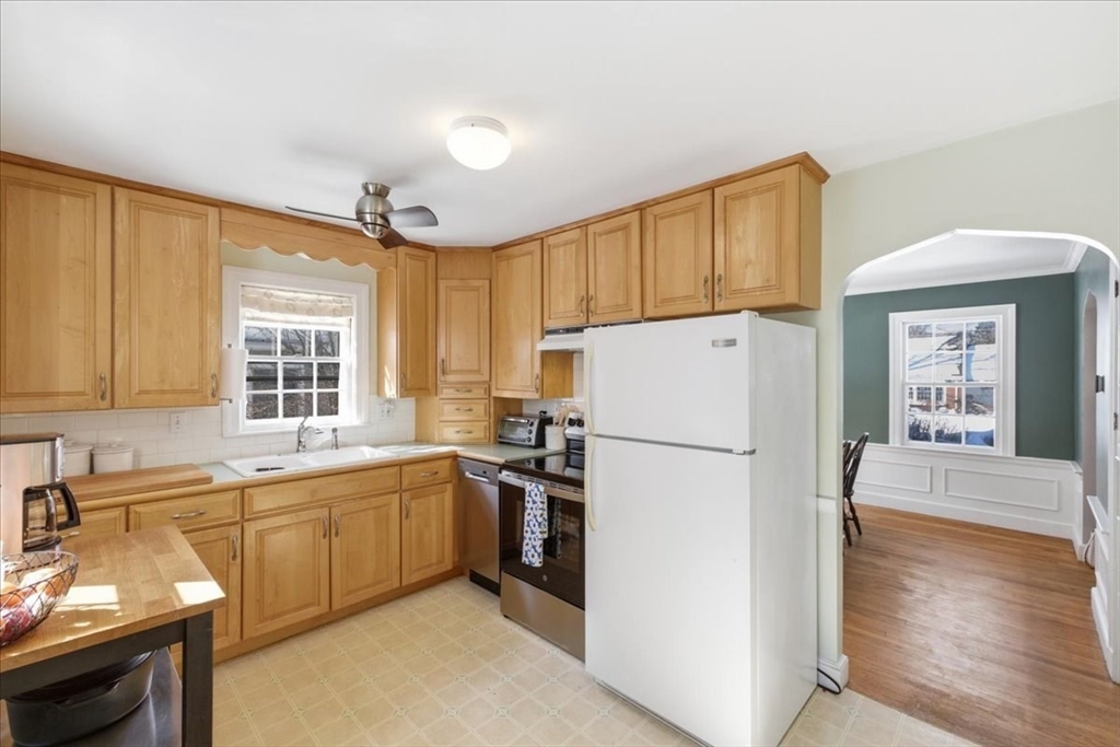 46 Park Street Dedham, MA 02026 - Photo 10 of 35 a kitchen with a sink a refrigerator and cabinets