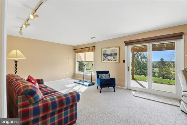 a bedroom with furniture and a large window