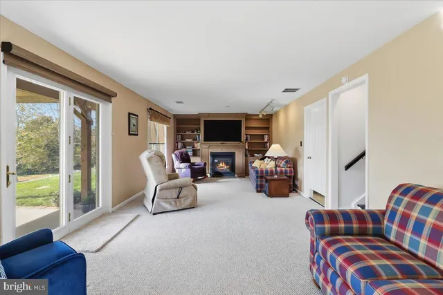 a living room with furniture fireplace and flat screen tv