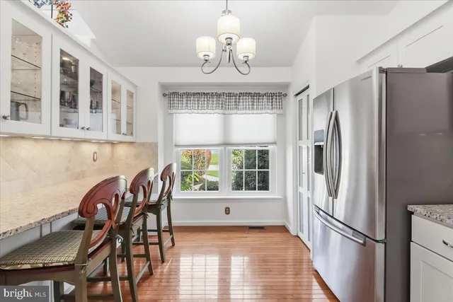 a kitchen with a refrigerator and a dining table