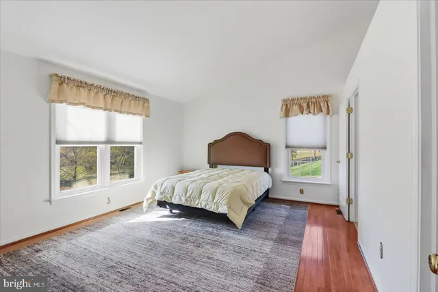 a spacious bedroom with a bed and a window