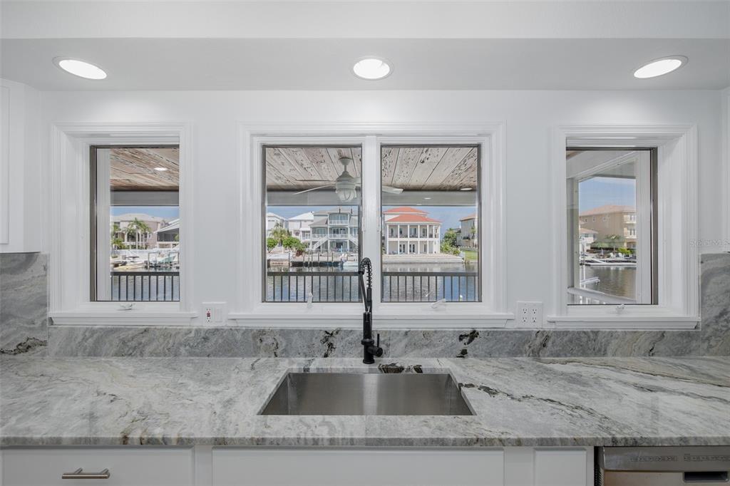 3150 Trident Terrace New Port Richey, FL 34652 - Photo 22 of 99 a kitchen with granite countertop a sink and a window