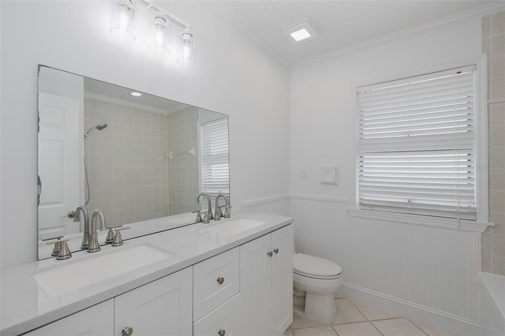 3150 Trident Terrace New Port Richey, FL 34652 - Photo 38 of 99 a bathroom with a toilet a sink a vanity and mirror