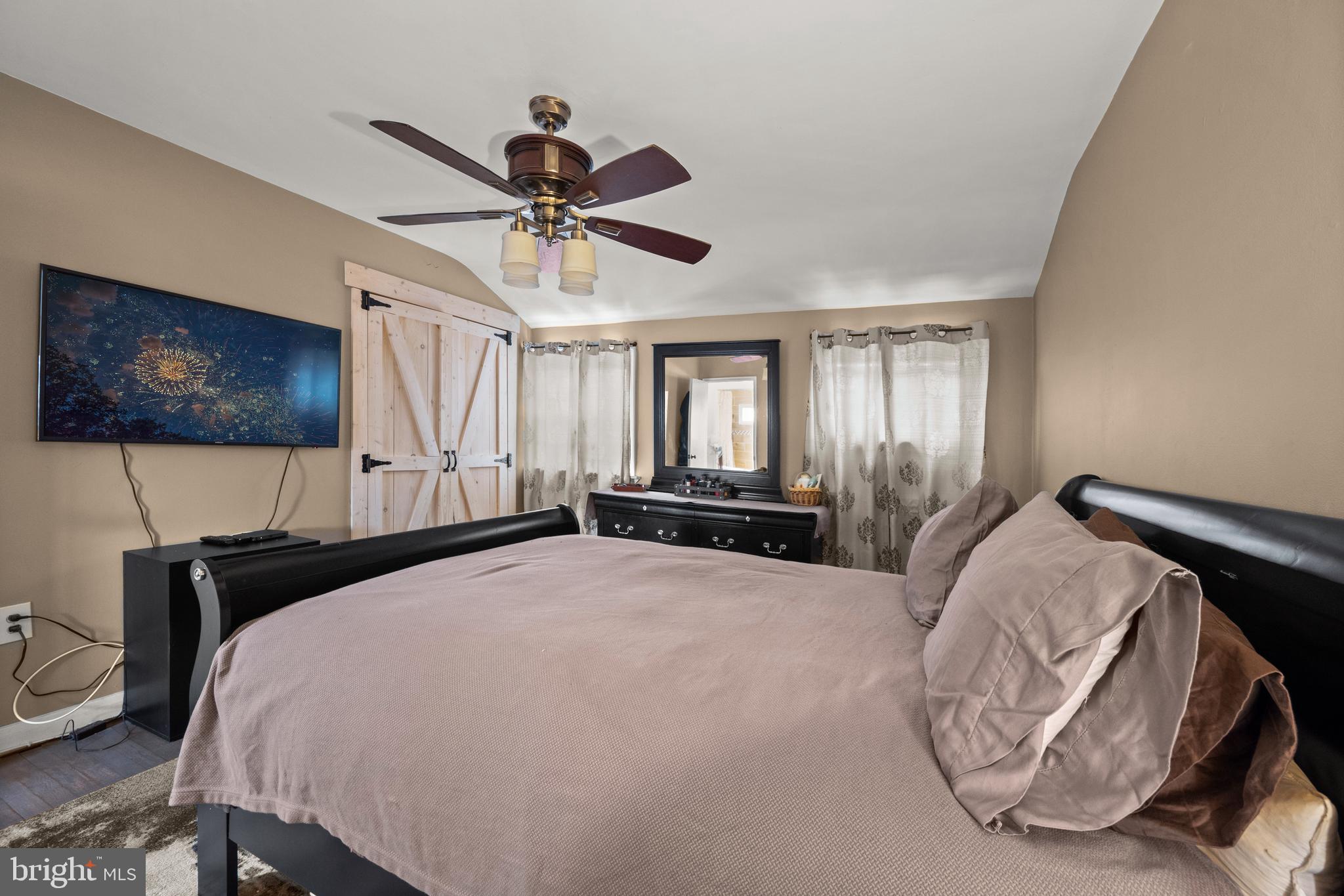 1955 Holborn Road Baltimore, MD 21222 - Photo 16 of 36 a spacious bedroom with a bed and a flat screen tv
