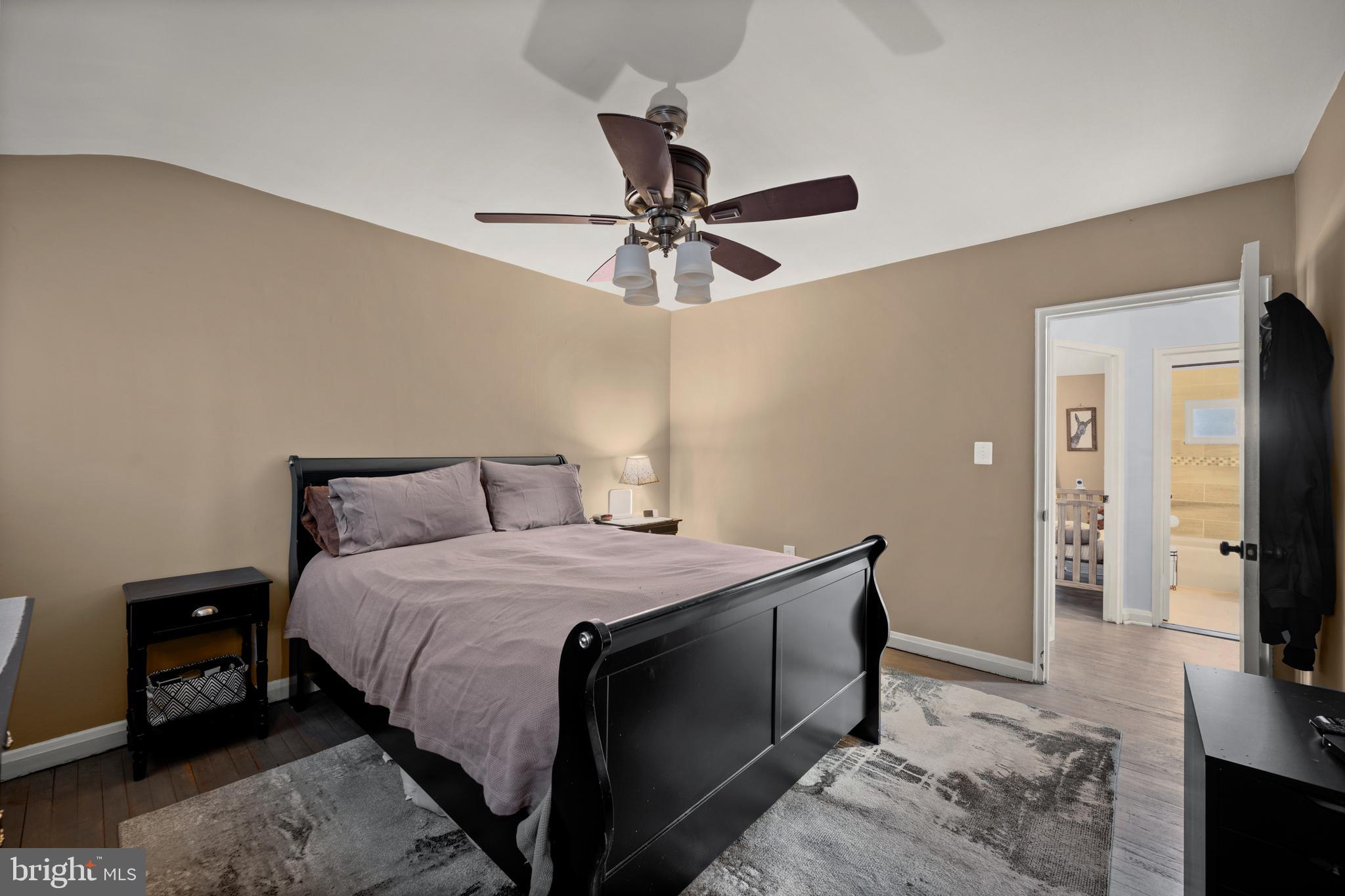 1955 Holborn Road Baltimore, MD 21222 - Photo 17 of 36 a bedroom with a bed and a flat tv screen on dresser