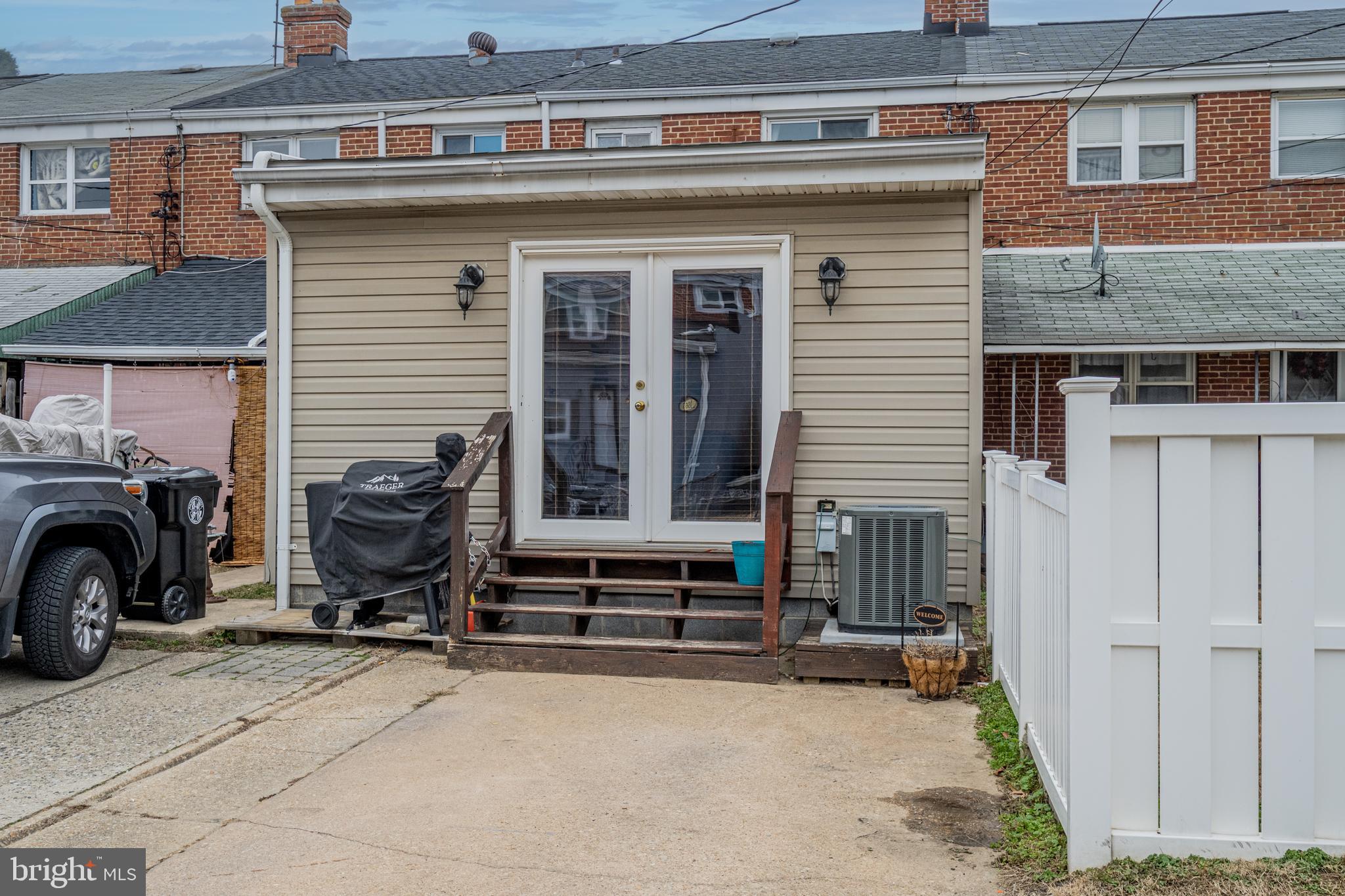 1955 Holborn Road Baltimore, MD 21222 - Photo 30 of 36 a view of a house with a barbeque and wooden stairs