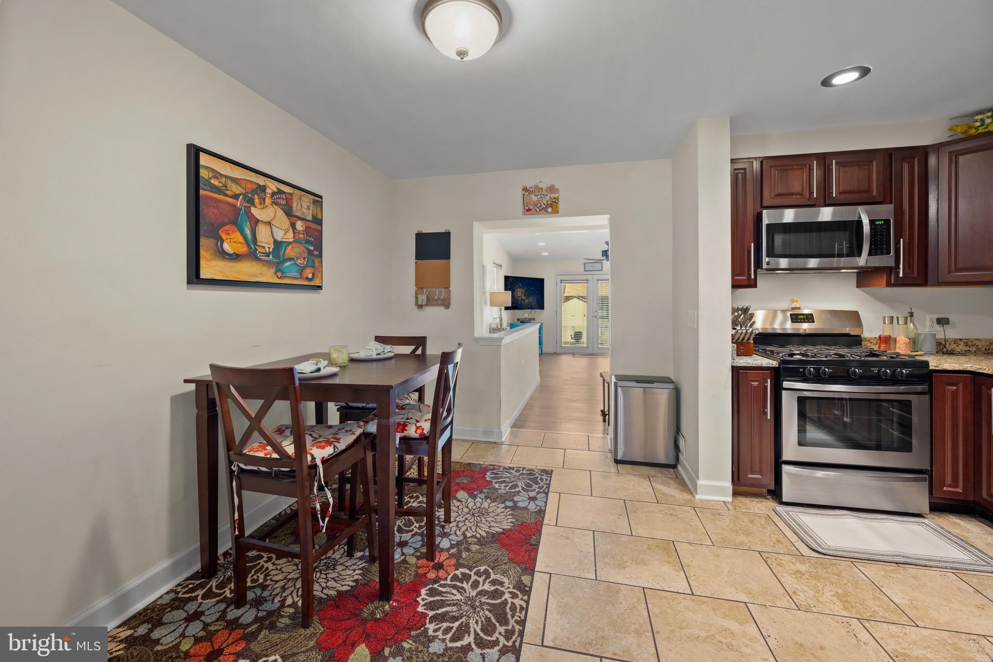 1955 Holborn Road Baltimore, MD 21222 - Photo 8 of 36 a living room with stainless steel appliances furniture a rug and a kitchen view