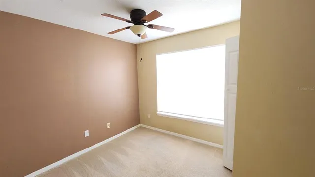 a view of an empty room and a window