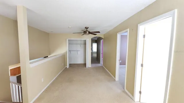 a view of a hallway view with staircase