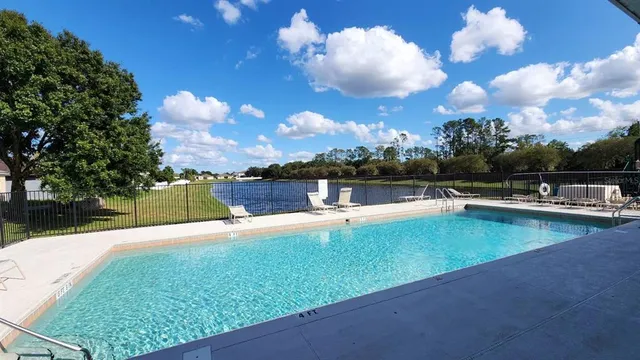 a view of a swimming pool with an outdoor seating and a yard