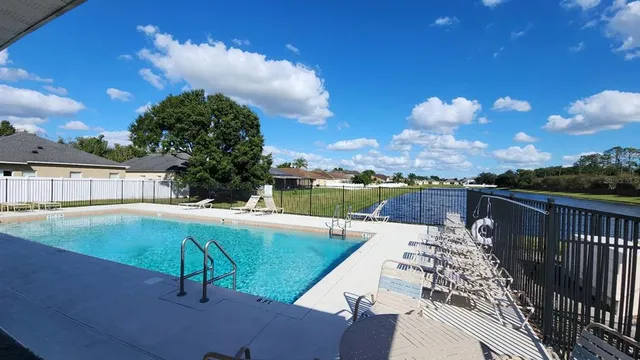 a view of a swimming pool with a lounge chairs
