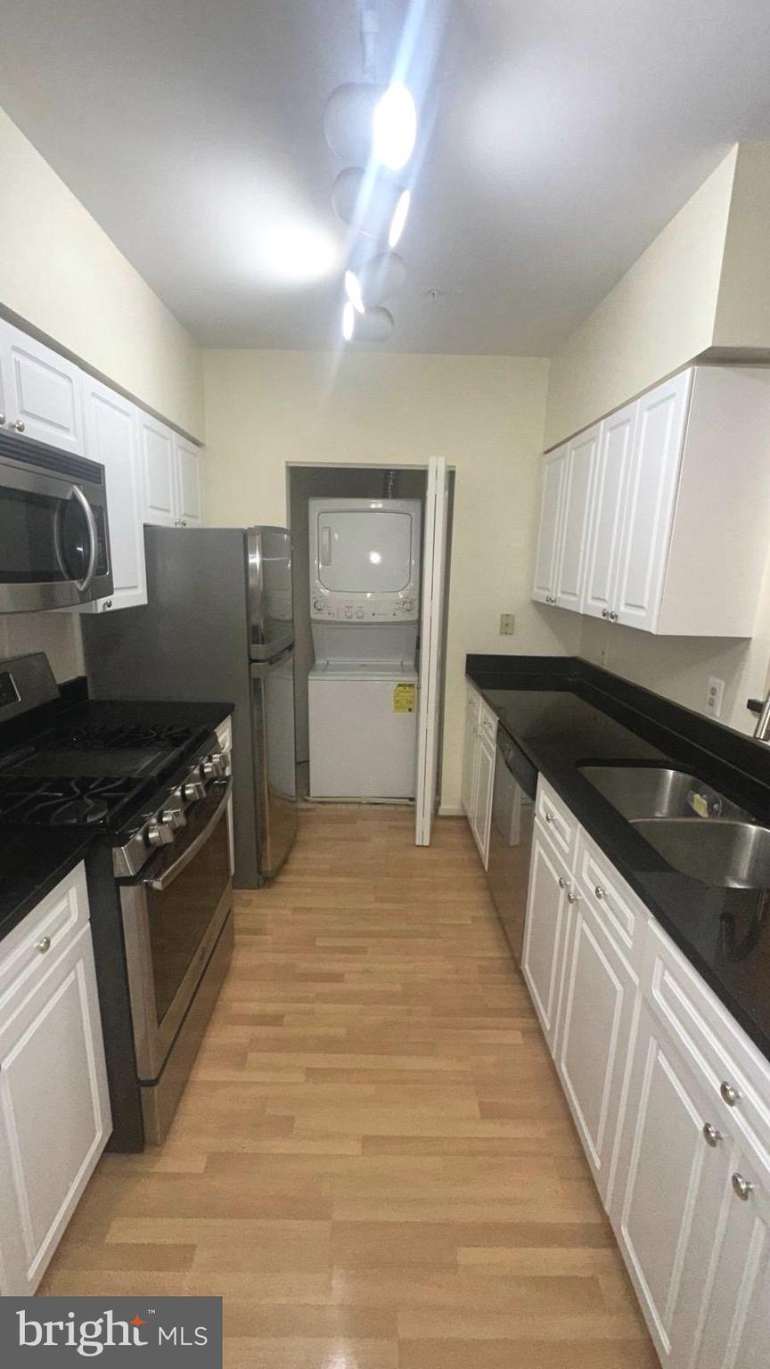 12919 Alton Square, Unit 203 Herndon, VA 20170 - Photo 5 of 22 a kitchen with stainless steel appliances granite countertop a stove a sink and a refrigerator