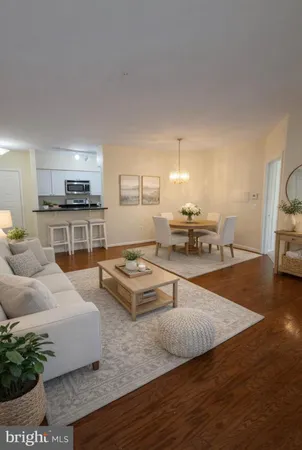 a living room with furniture and a kitchen