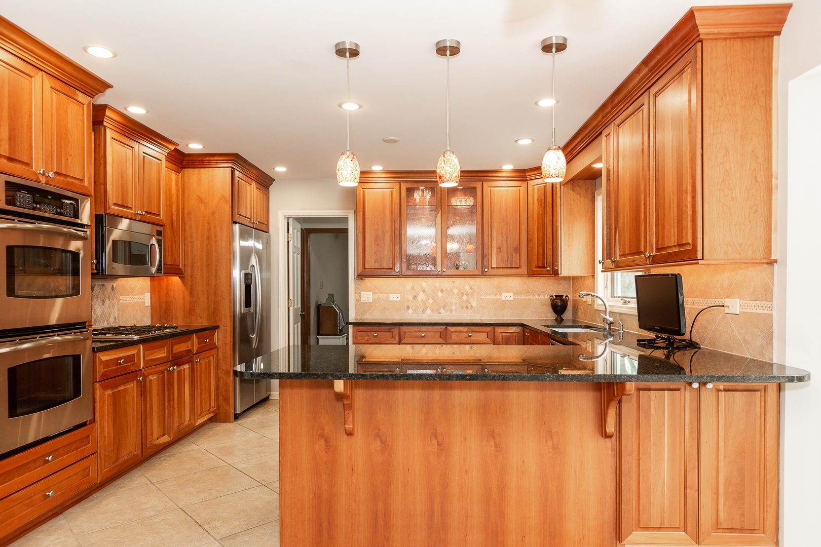 620 Buttonwood Circle Naperville, IL 60540 - Photo 2 of 29 a kitchen with stainless steel appliances granite countertop a refrigerator a stove and a sink with wooden floor