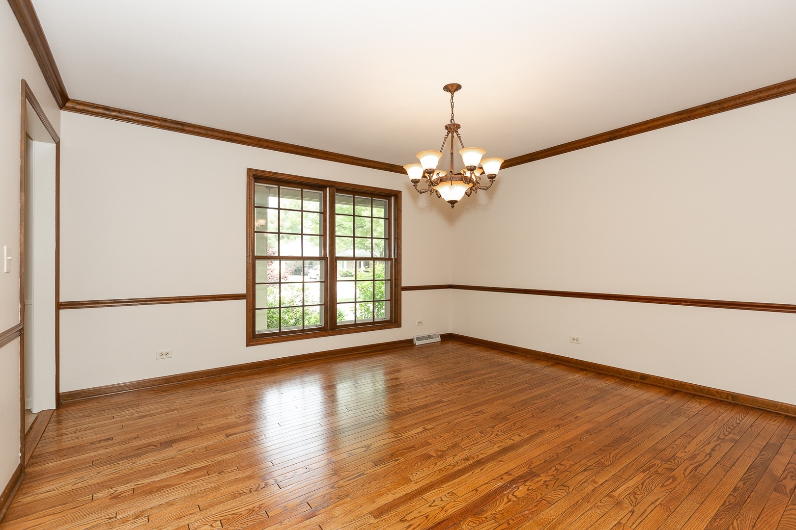 620 Buttonwood Circle Naperville, IL 60540 - Photo 11 of 29 a view of an empty room with wooden floor and a window