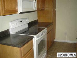 816 Raindrops Road Gastonia, NC 28054 - Photo 3 of 8 a kitchen with a sink a microwave and cabinets