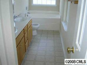 816 Raindrops Road Gastonia, NC 28054 - Photo 4 of 8 a bathroom with a sink a toilet and shower