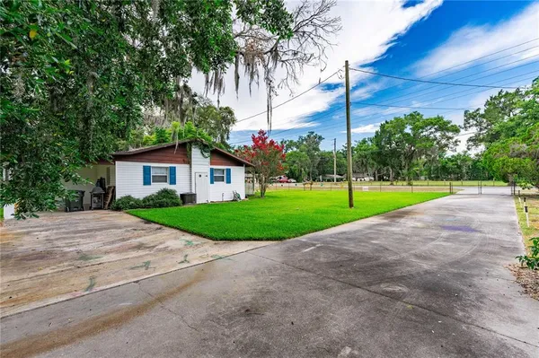 a view of a house with a backyard