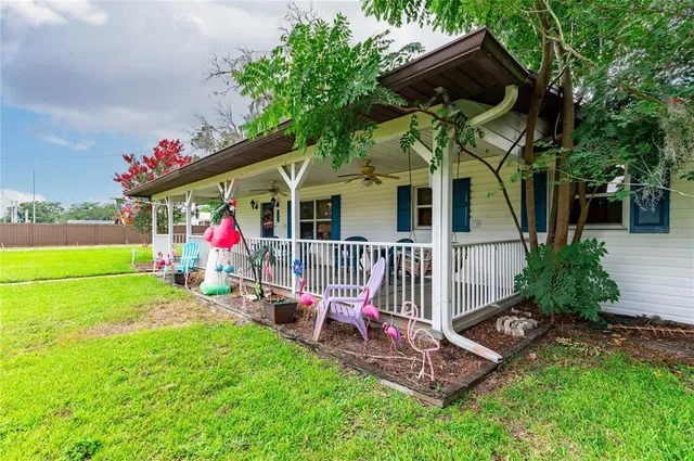 a view of a porch with furniture and garden