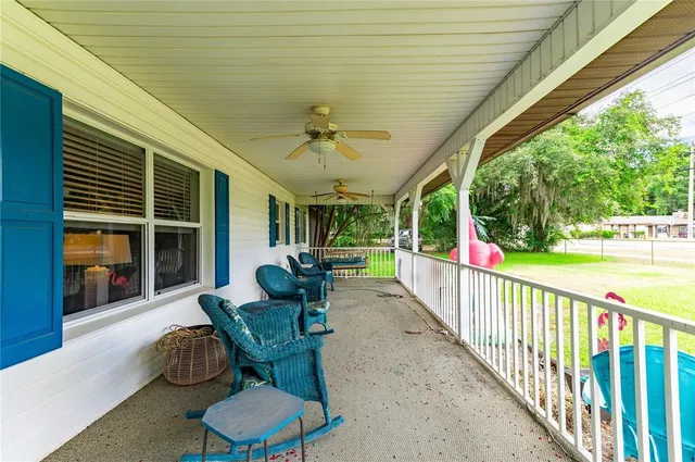 a dining room with furniture water view and a floor to ceiling window