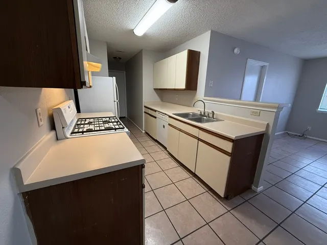 a kitchen with a sink cabinets and appliances