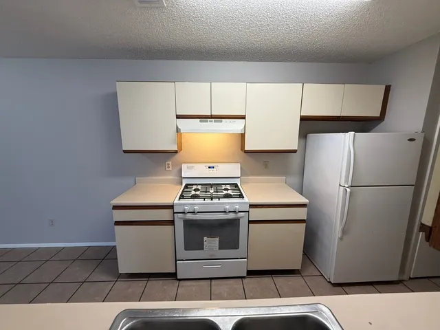 a kitchen with a stove and a refrigerator