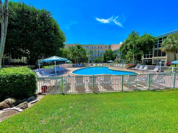 a view of a house with a yard and sitting area