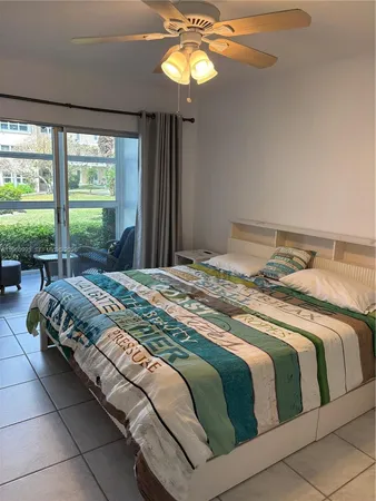 a bedroom with a bed and a large window