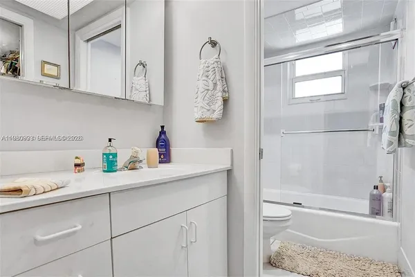 a bathroom with a sink a toilet and a bathtub