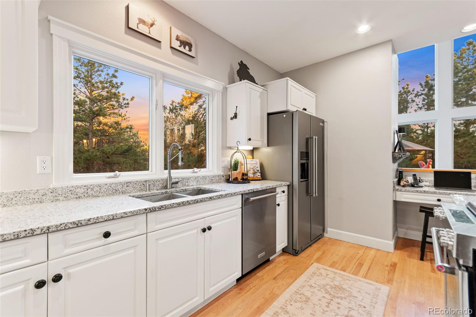 5090 South Perry Park Road Sedalia, CO 80135 - Photo 12 of 50 a kitchen with stainless steel appliances granite countertop a refrigerator and a sink