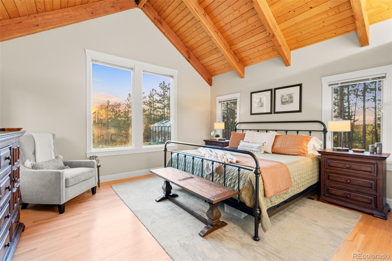 5090 South Perry Park Road Sedalia, CO 80135 - Photo 16 of 50 a spacious bedroom with a bed and a couch