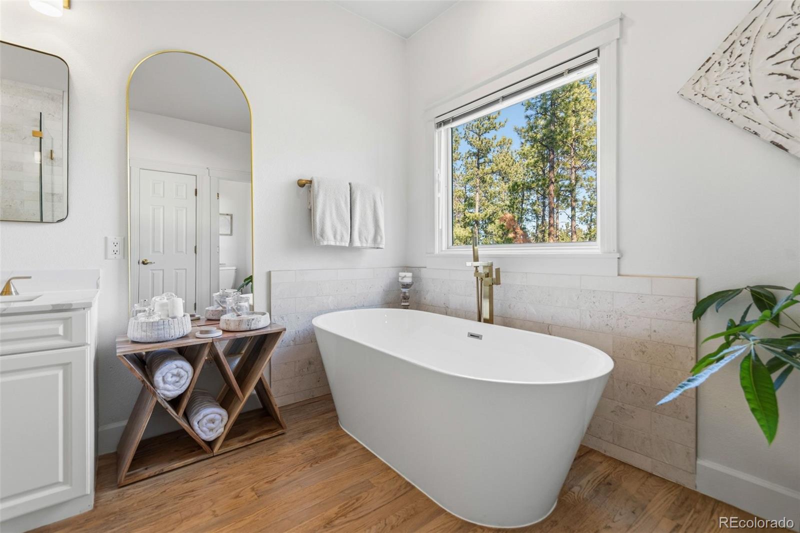 5090 South Perry Park Road Sedalia, CO 80135 - Photo 21 of 50 a white bath tub sitting next to a white sink