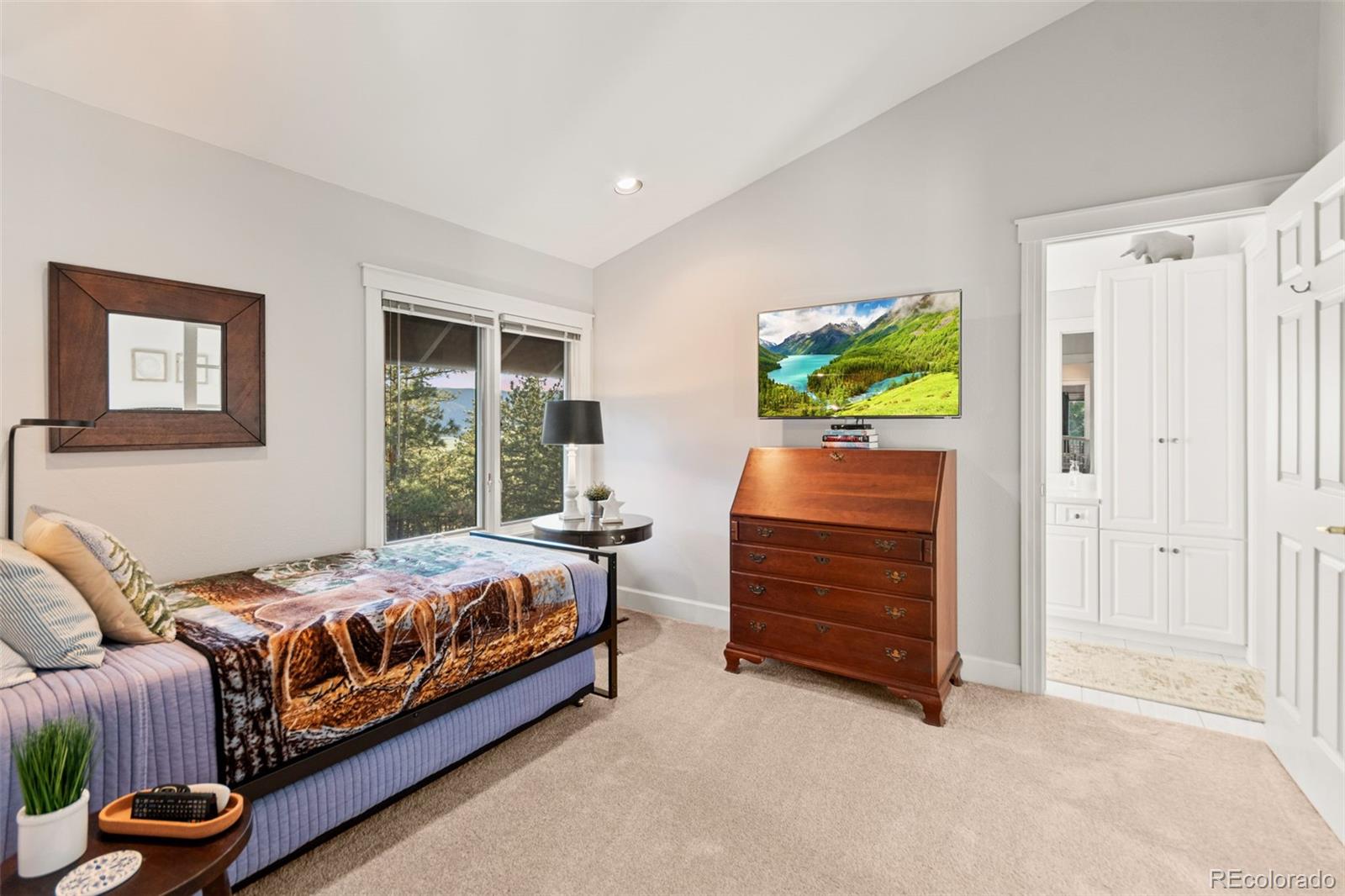 5090 South Perry Park Road Sedalia, CO 80135 - Photo 22 of 50 a bedroom with a bed and a dresser