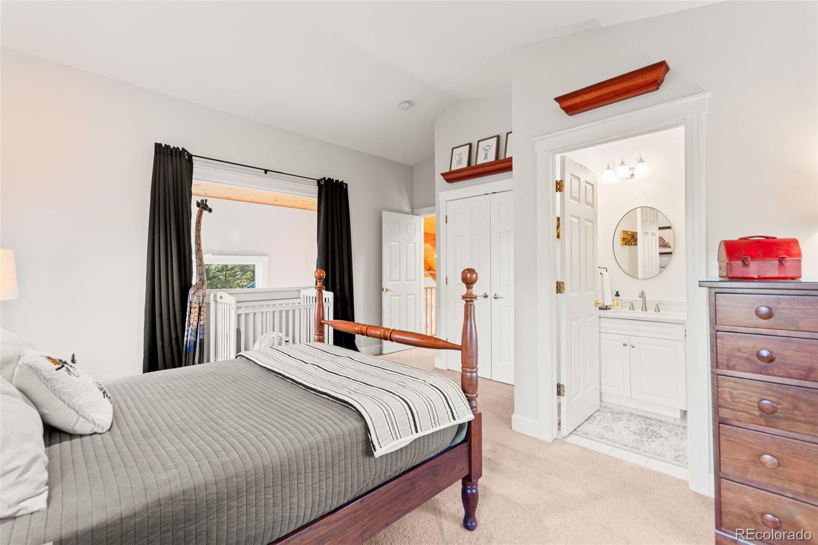 5090 South Perry Park Road Sedalia, CO 80135 - Photo 27 of 50 a bedroom with a bed and a dresser