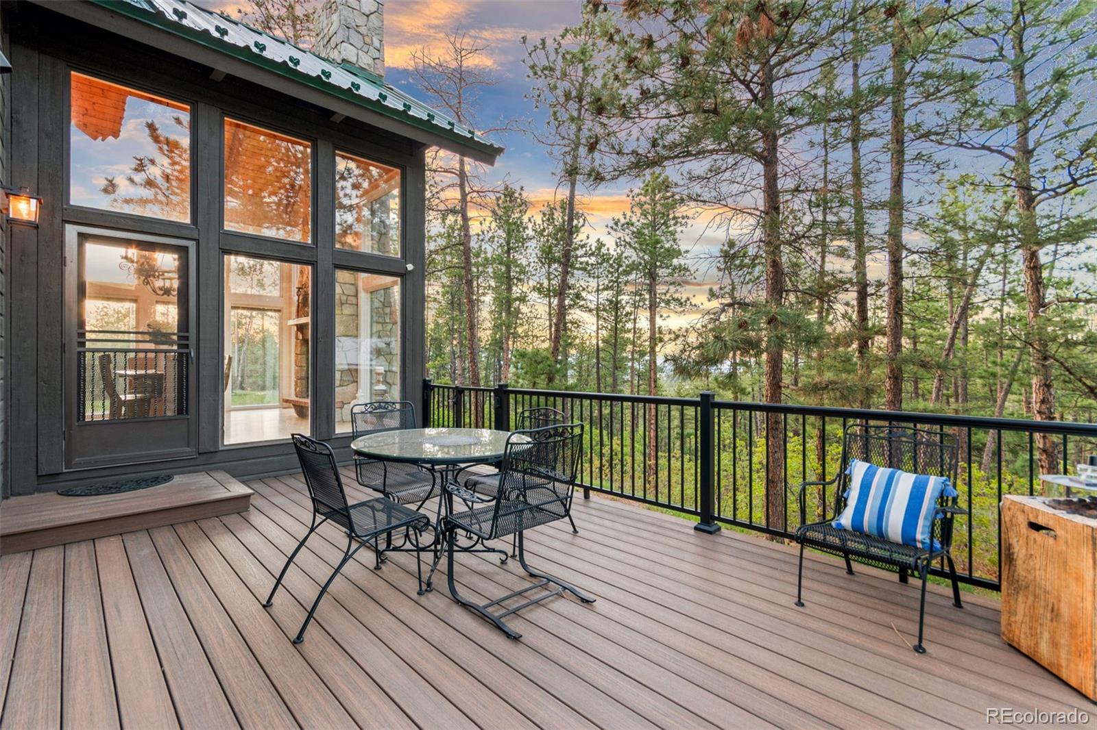 5090 South Perry Park Road Sedalia, CO 80135 - Photo 34 of 50 a view of a balcony with chairs and wooden floor