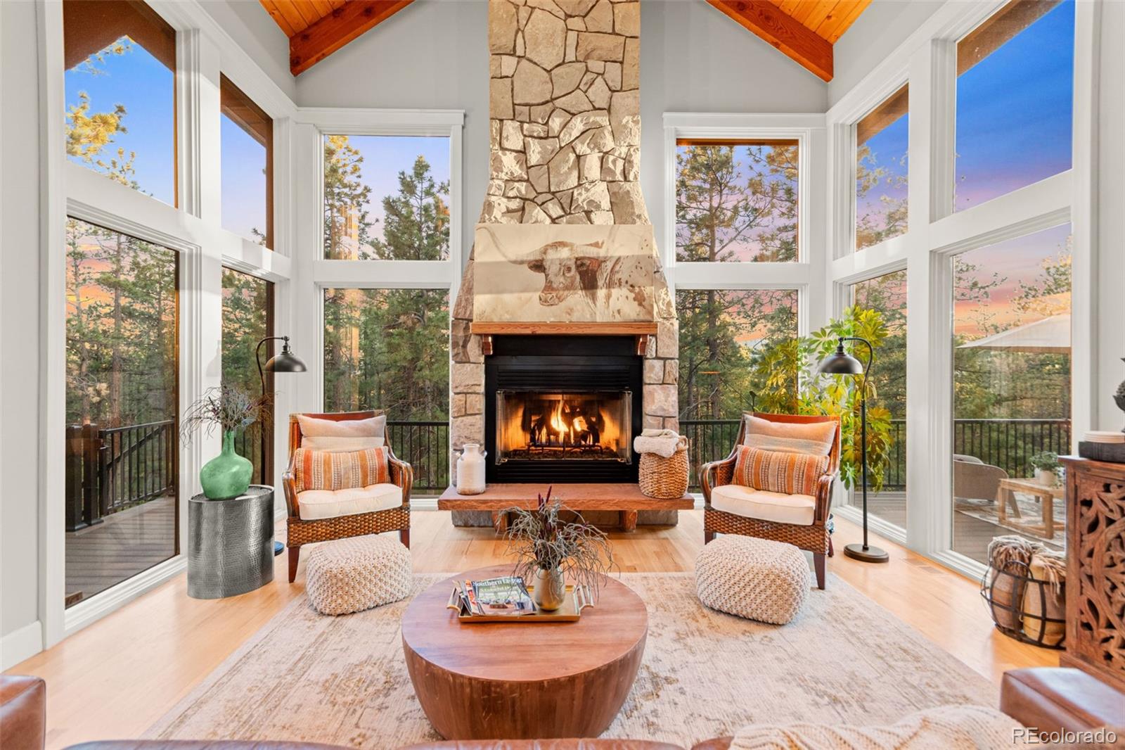 5090 South Perry Park Road Sedalia, CO 80135 - Photo 6 of 50 a living room with furniture a fireplace and a floor to ceiling window