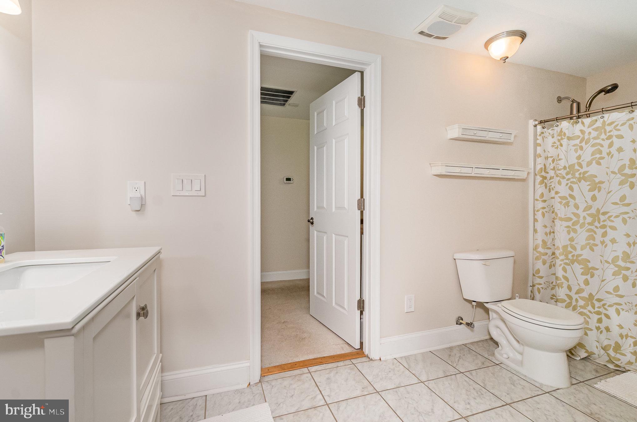 2414 Laurel Bush Road Abingdon, MD 21009 - Photo 38 of 68 a bathroom with a granite countertop sink a toilet and a shower