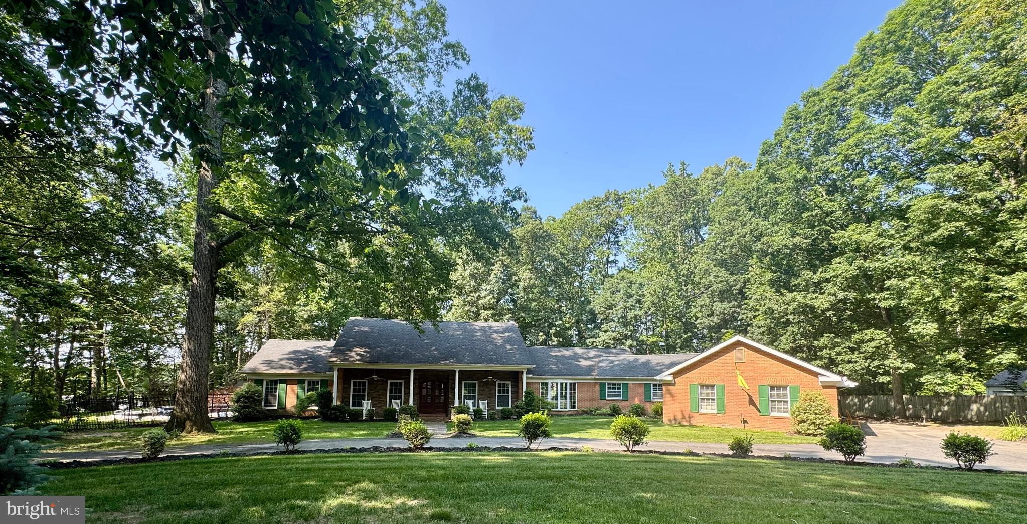 2414 Laurel Bush Road Abingdon, MD 21009 - Photo 4 of 68 a front view of a house with a garden and trees