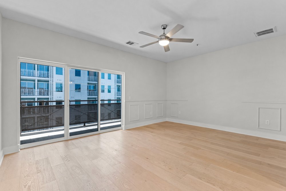 2827 Manor Road, Unit 2201 Austin, TX 78722 - Photo 28 of 40 Hardwood flooring and expansive sliding glass doors opening to a balcony