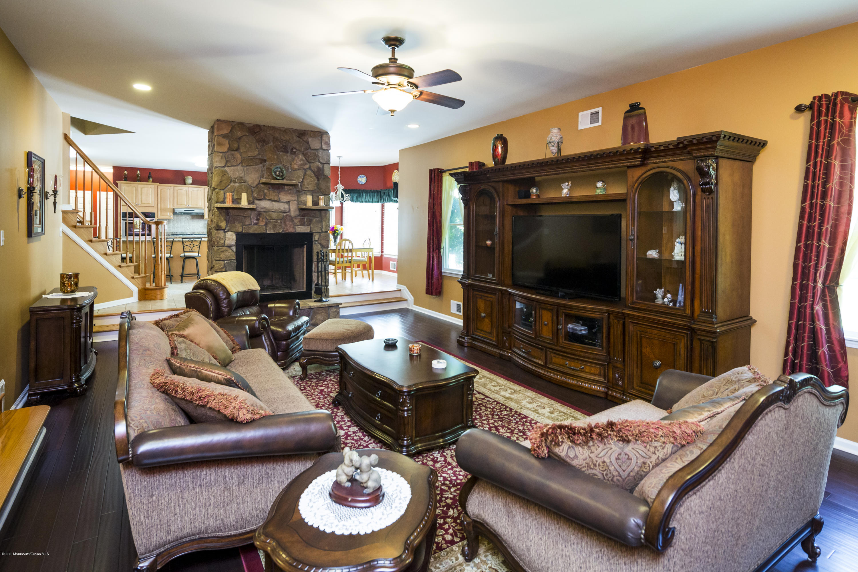 55 Spring Road Clarksburg, NJ 08510 - Photo 13 of 44 a living room with furniture a fireplace and a flat screen tv