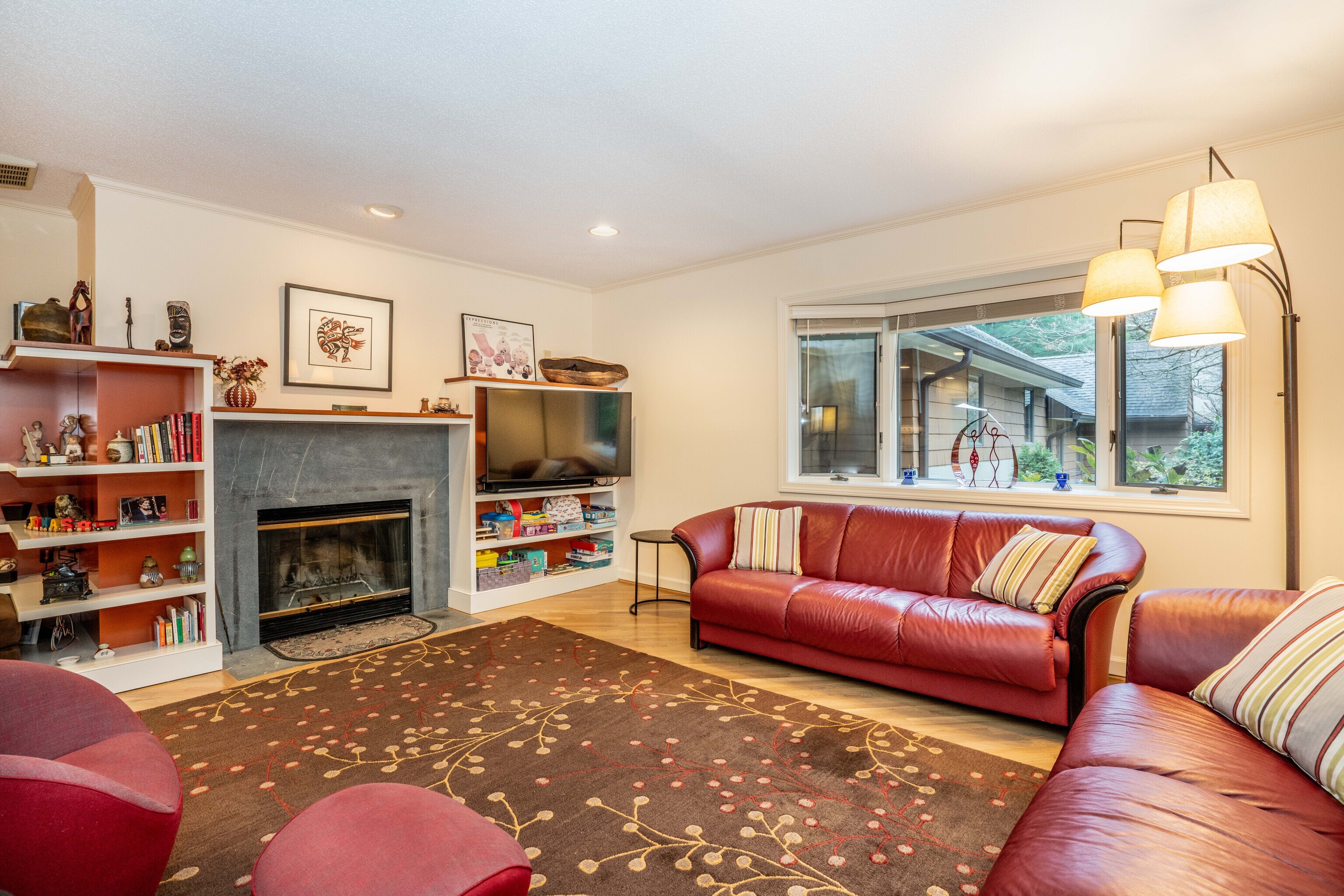 34 Cary Lane, Unit 34 Bloomfield, CT 06002 - Photo 26 of 40 a living room with furniture a flat screen tv and a fireplace