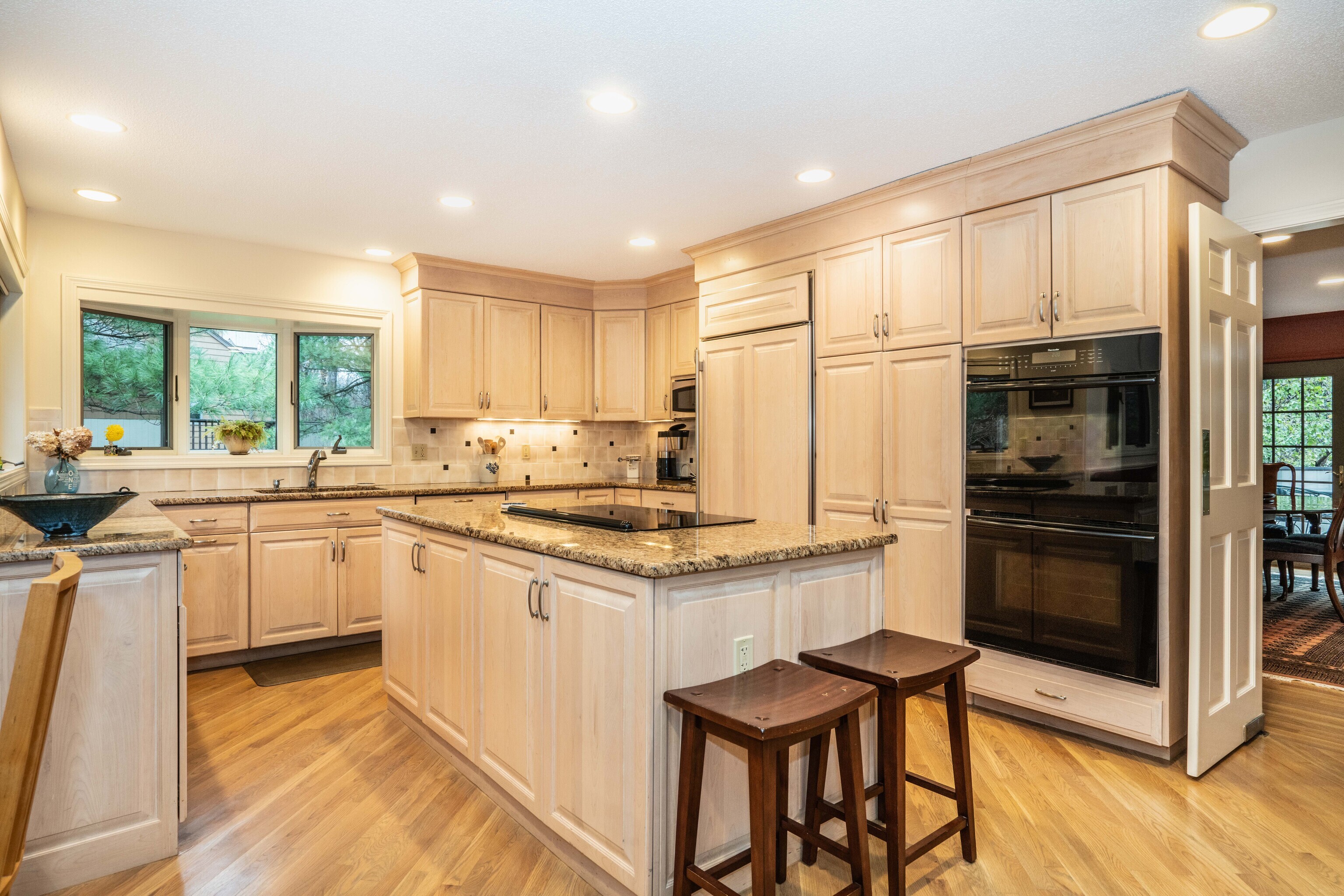 34 Cary Lane, Unit 34 Bloomfield, CT 06002 - Photo 9 of 40 a kitchen with stainless steel appliances granite countertop a stove a sink a refrigerator and white cabinets with wooden floor