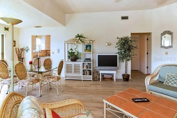 a living room with furniture flat screen tv and wooden floor