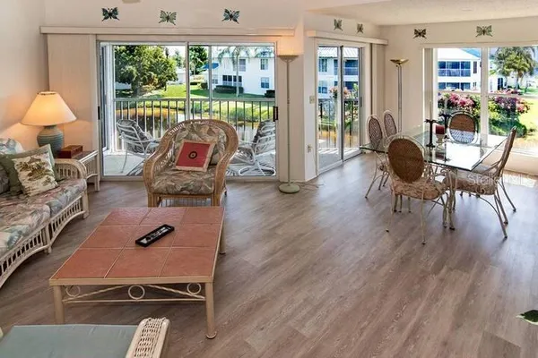 a living room with furniture and a floor to ceiling window