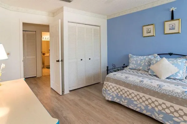 a bedroom with a bed and wooden floor