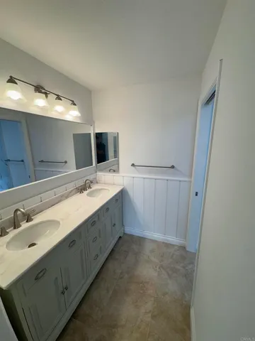 a bathroom with a sink double vanity and a mirror