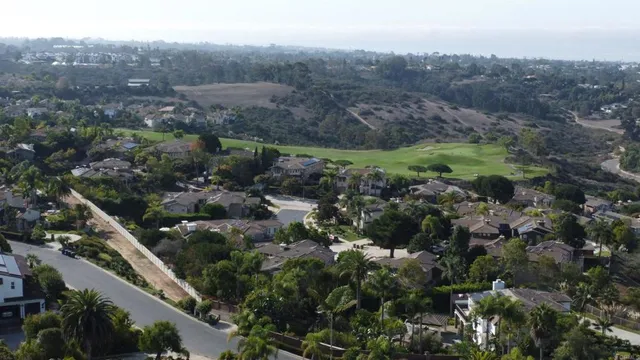 an aerial view of residential house with green space