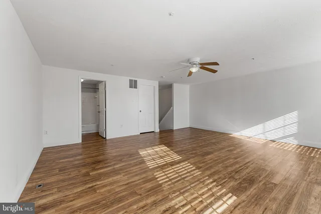 a view of an empty room and wooden floor