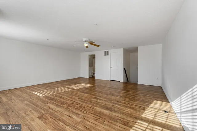 a view of an empty room and wooden floor